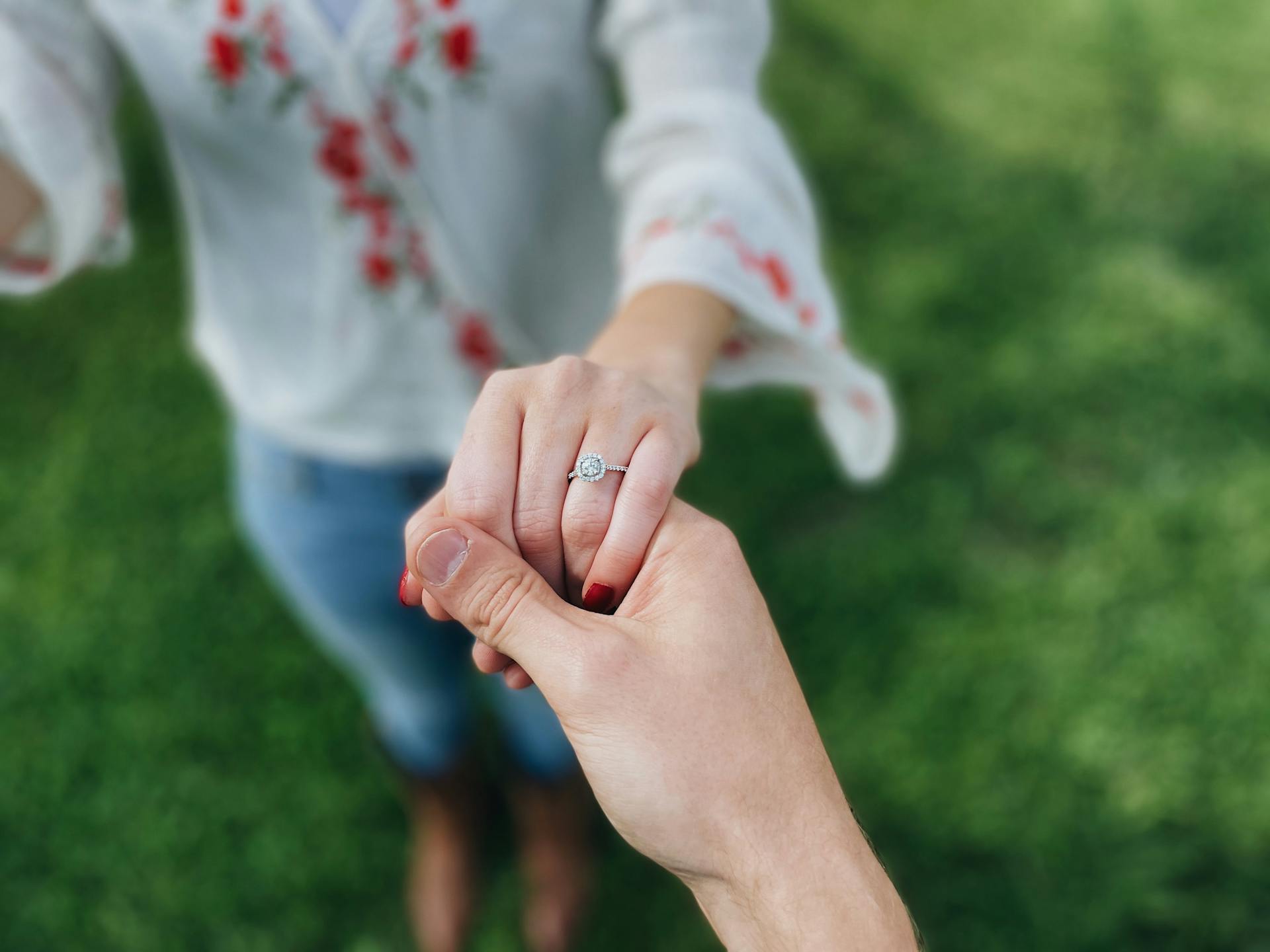 womans hand showing off engagement ring