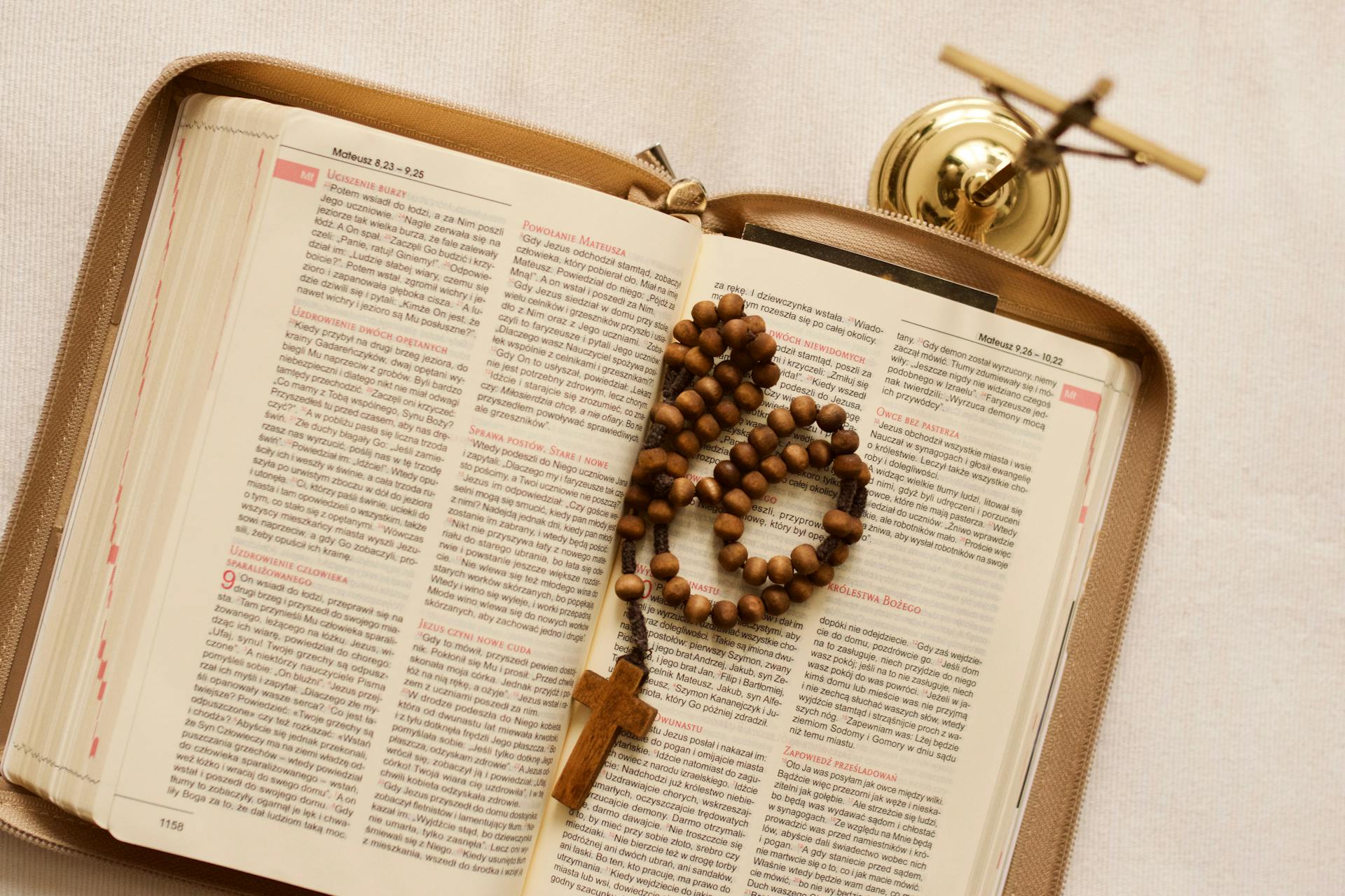 an open bible with rosary beads