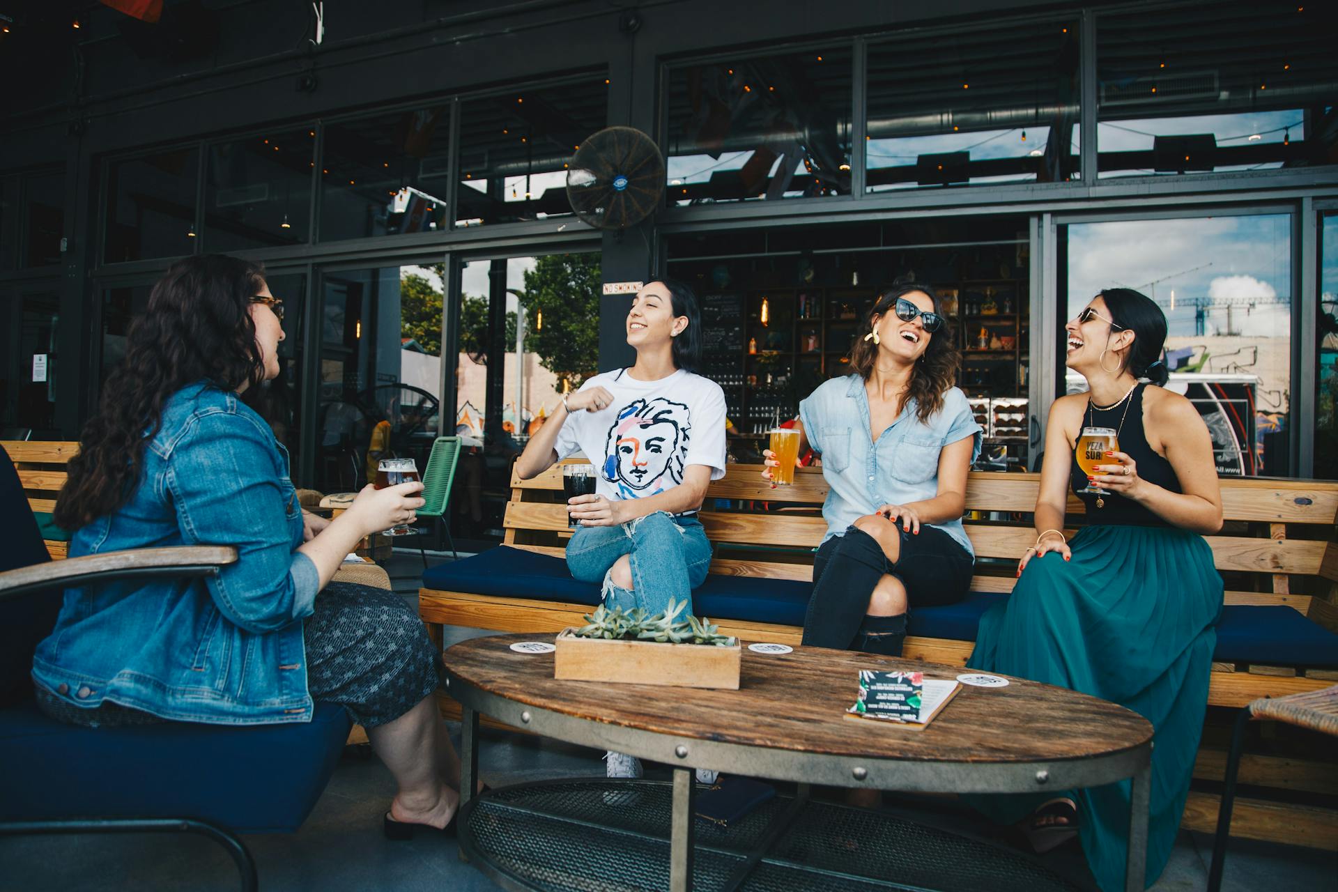 four women friends laughing and loving each other