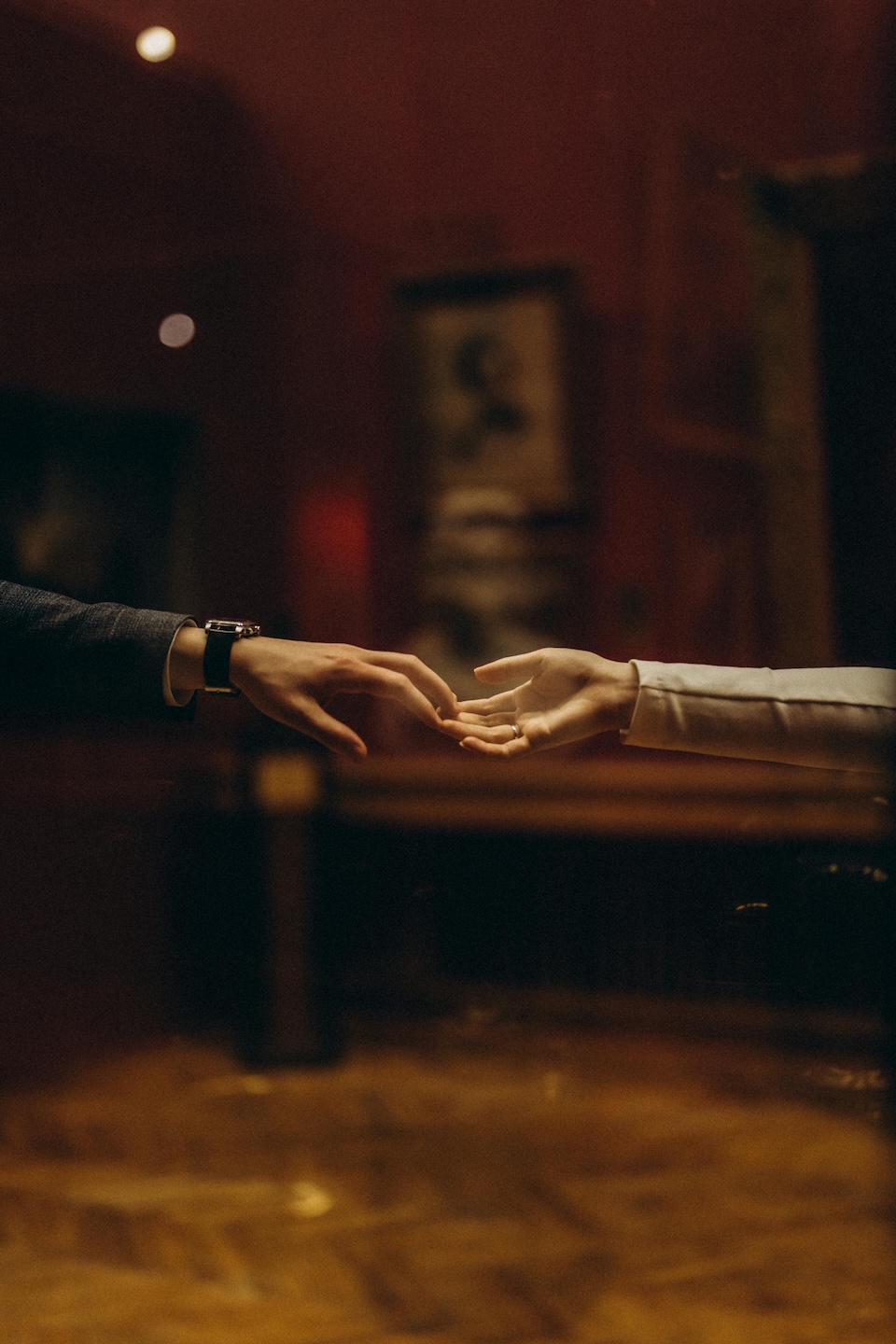 two hands reaching for each other