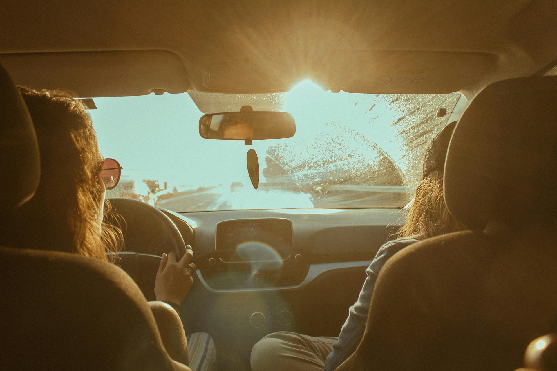 two women driving off into the sunset