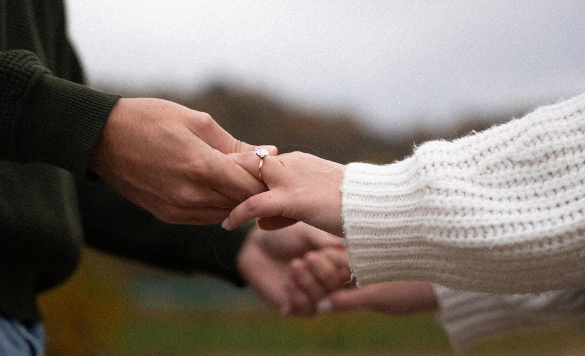 close up of couple holding hands after engagement