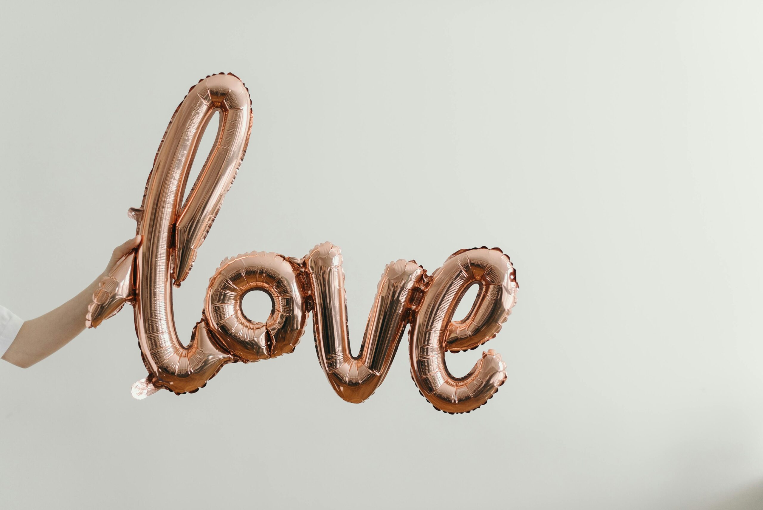 rose gold inflated balloon spelling love