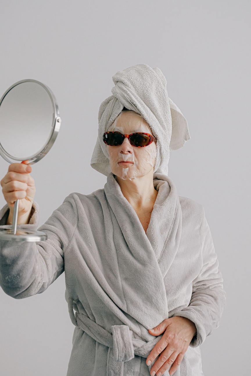 woman in a bathrobe and face mask
