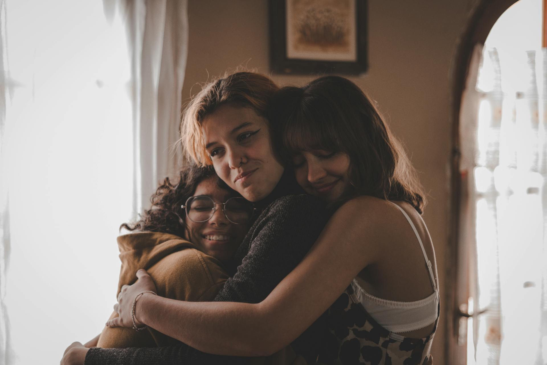 a group of women friends embracing each other