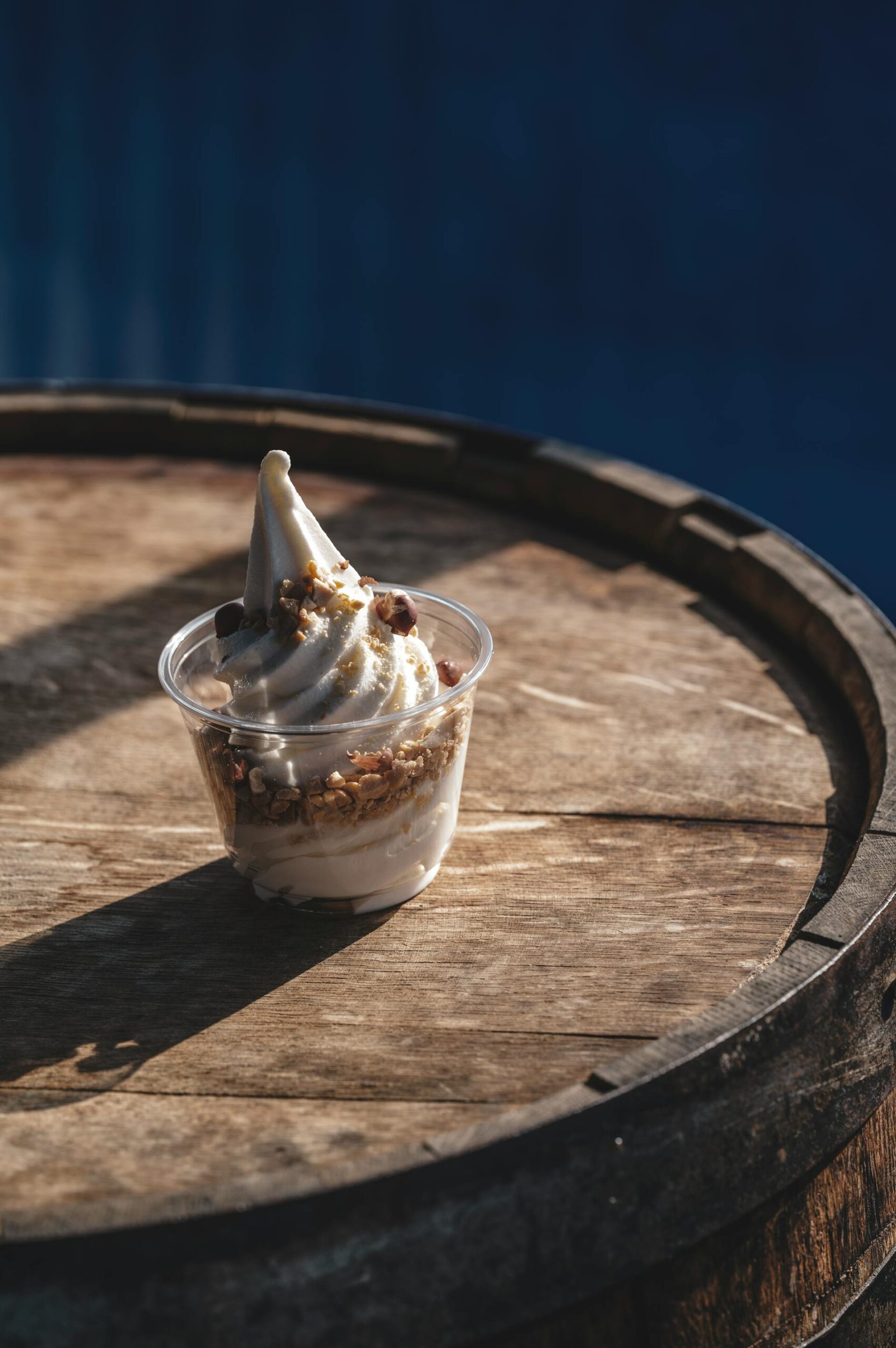 fro yo in a plastic cup on a barrel