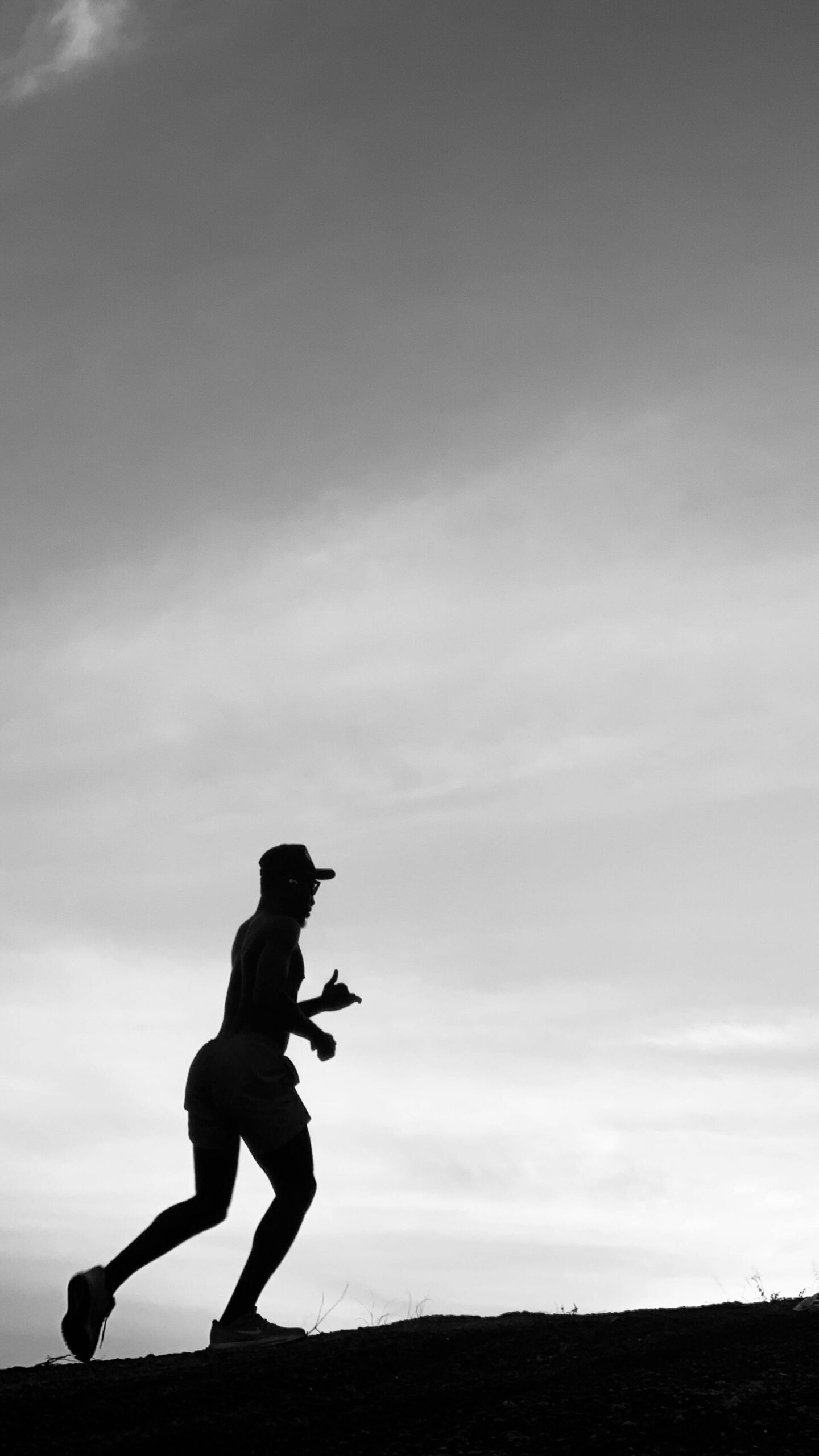 silhouette of a person running at sunset