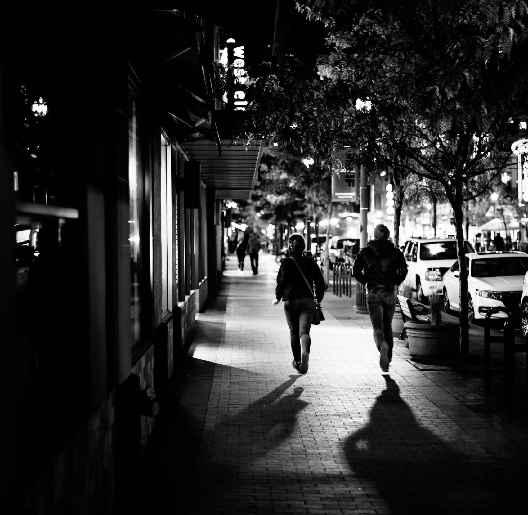 two people walking down the street