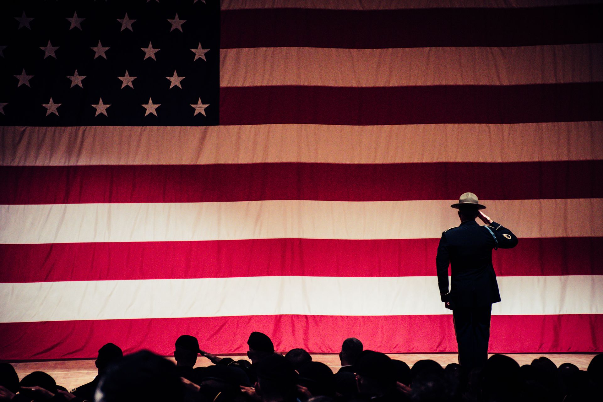 a soldier solutes an american flag