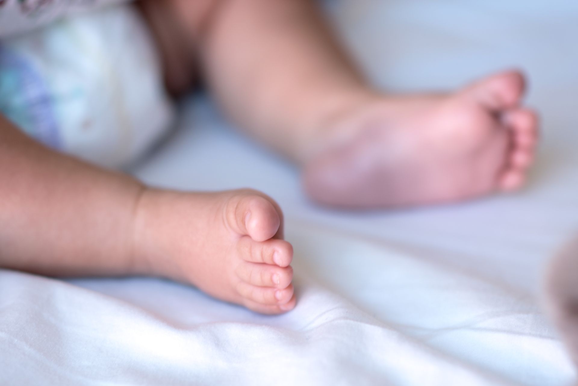 newborn baby feet on a blanket