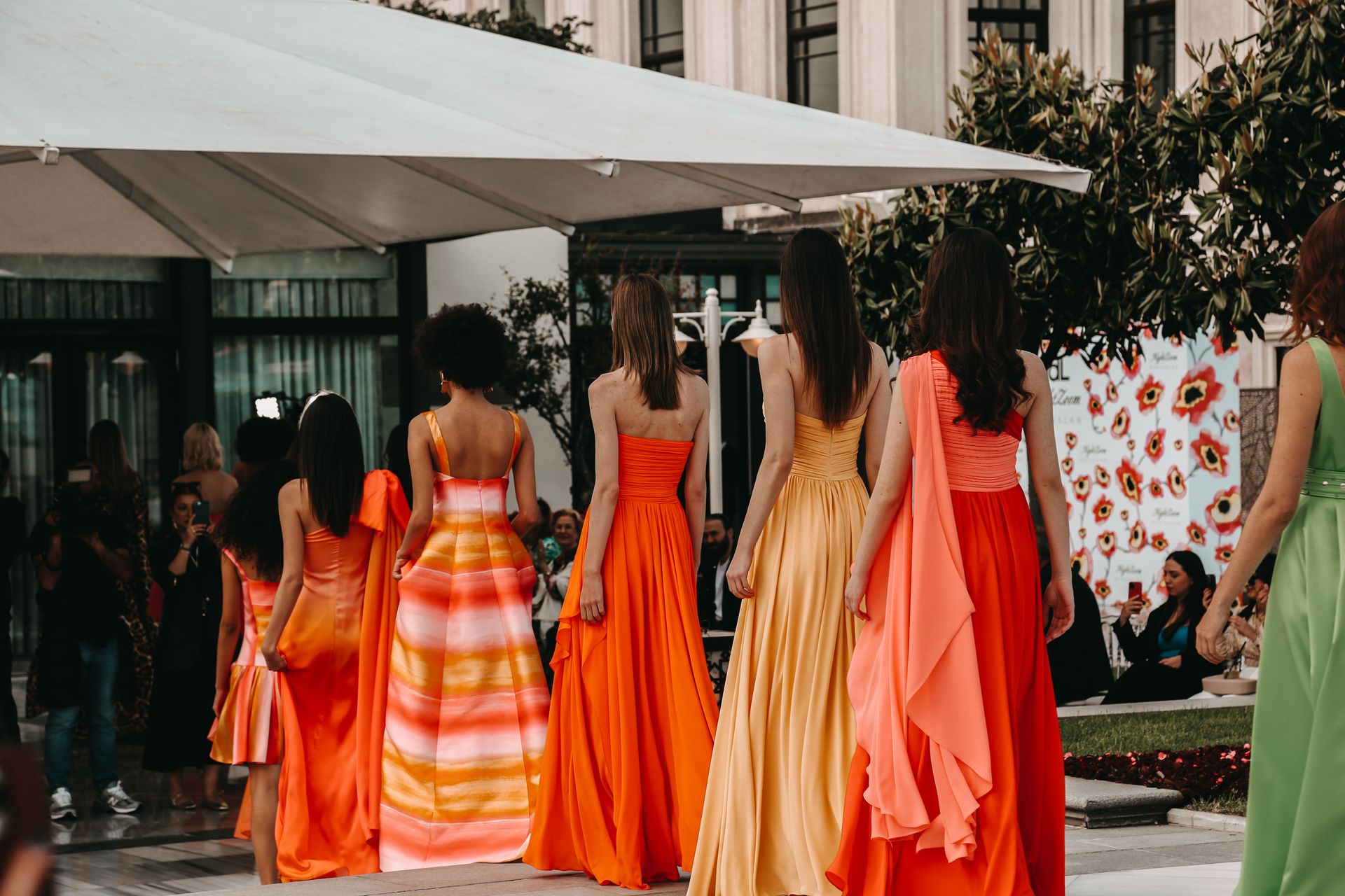 women in gowns line up to enter building