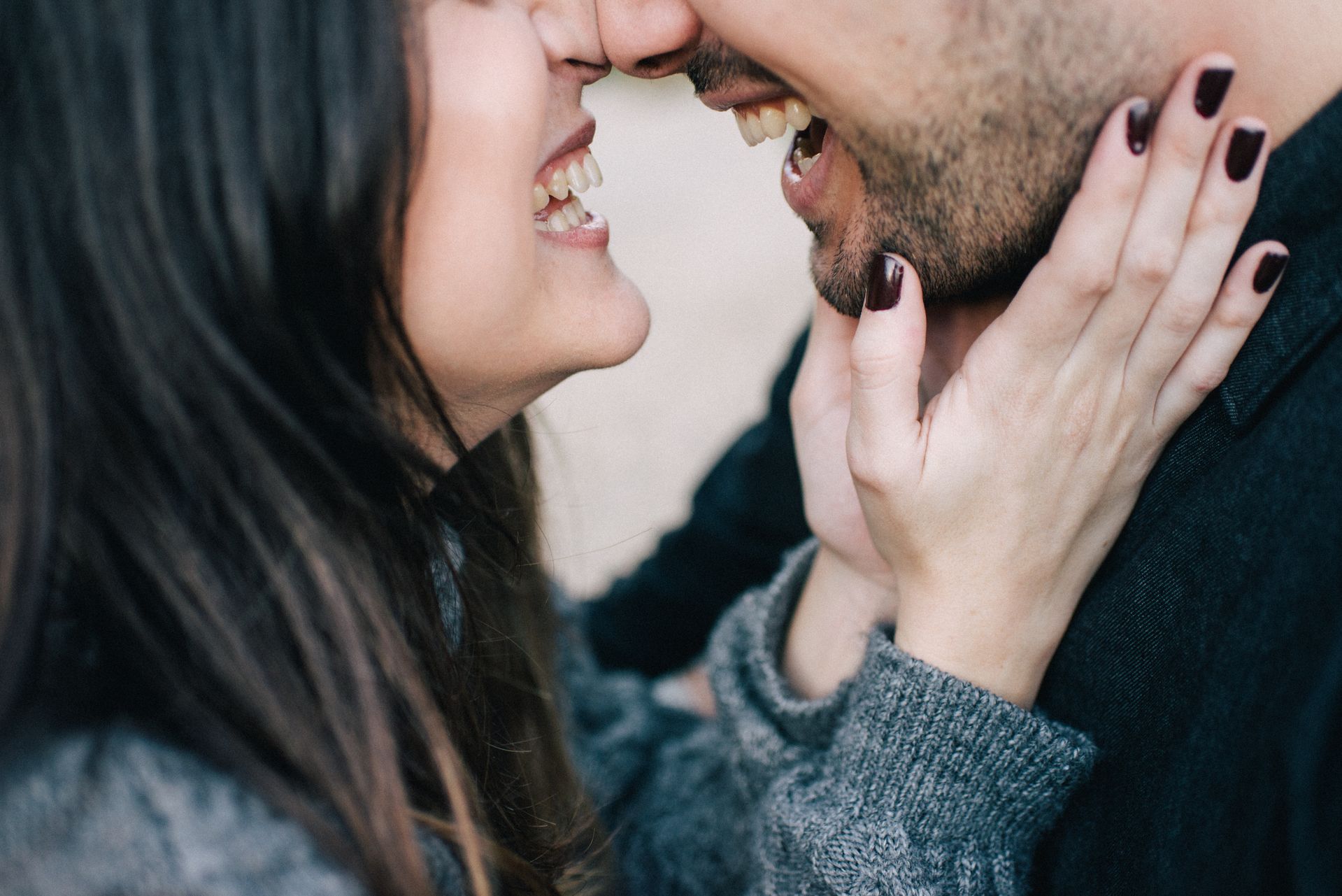 a couple touching foreheads laughing