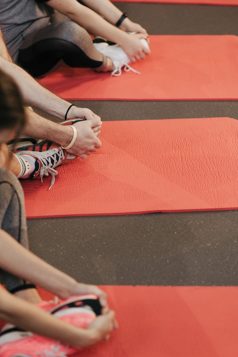 people stretching on yoga mats