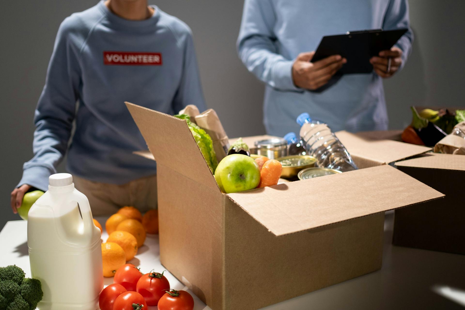 volunteers with a box of food and drinks