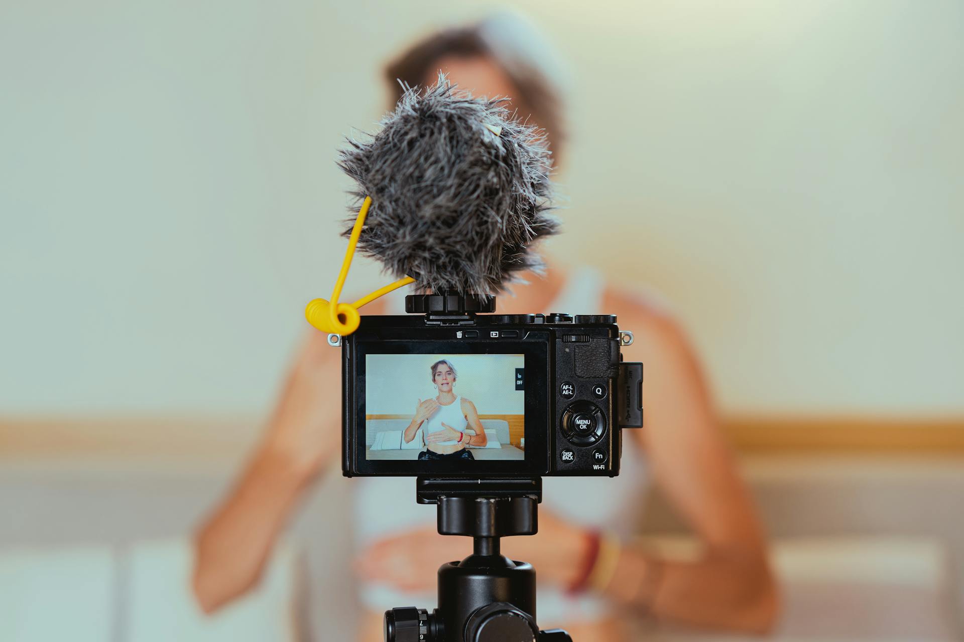Shallow Focus Photo of a Video Camera Recording a woman