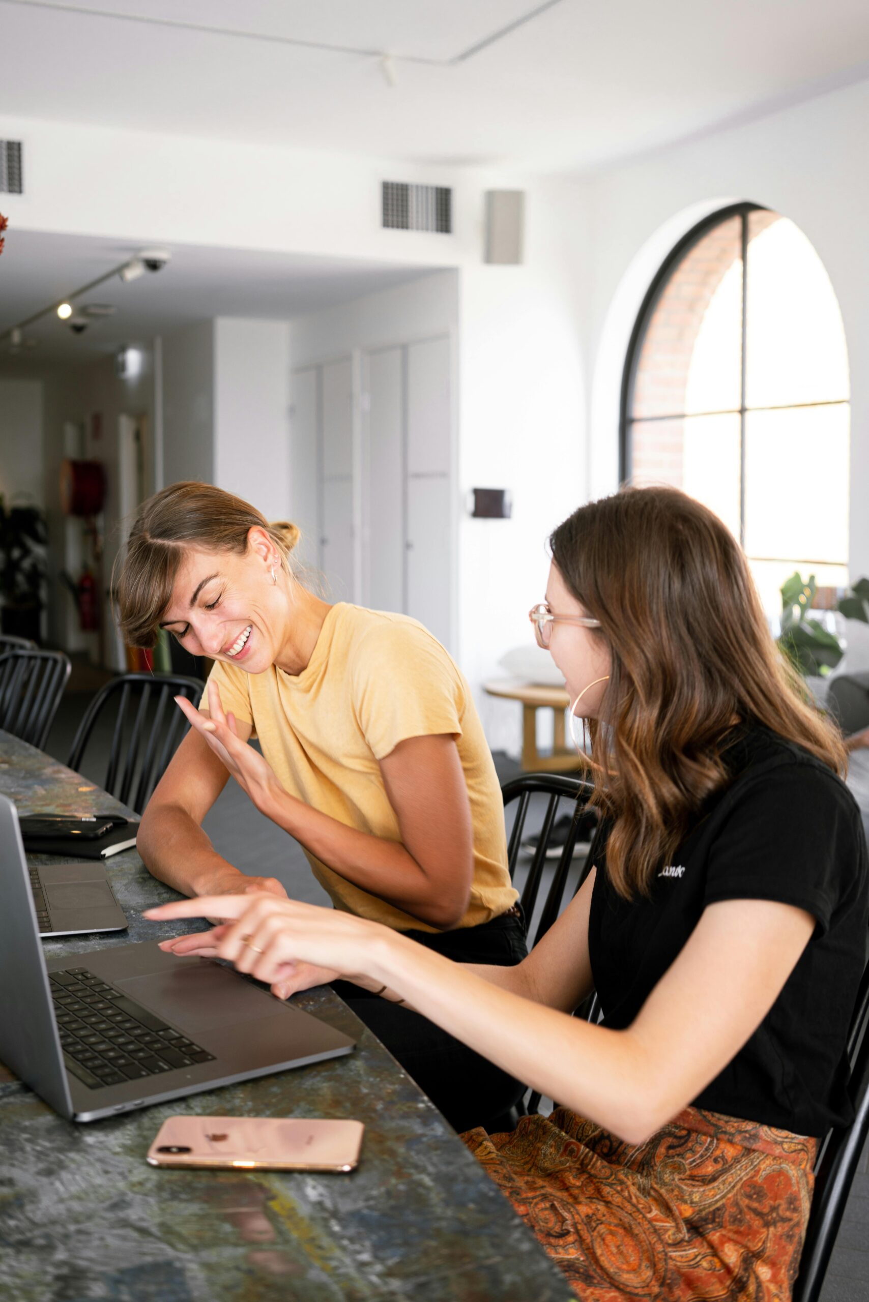 friends laughing together while working remotely