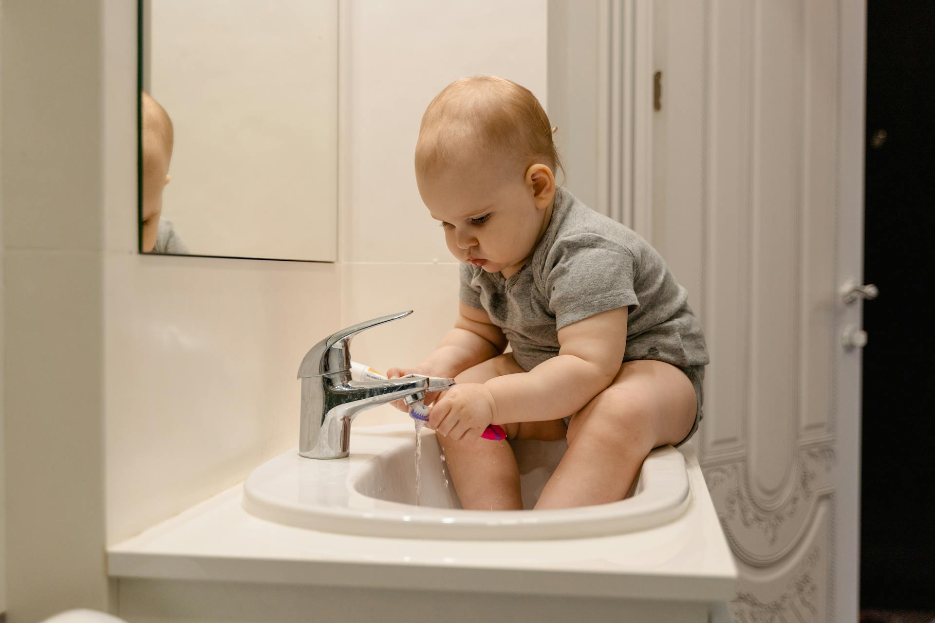 baby sitting on sink