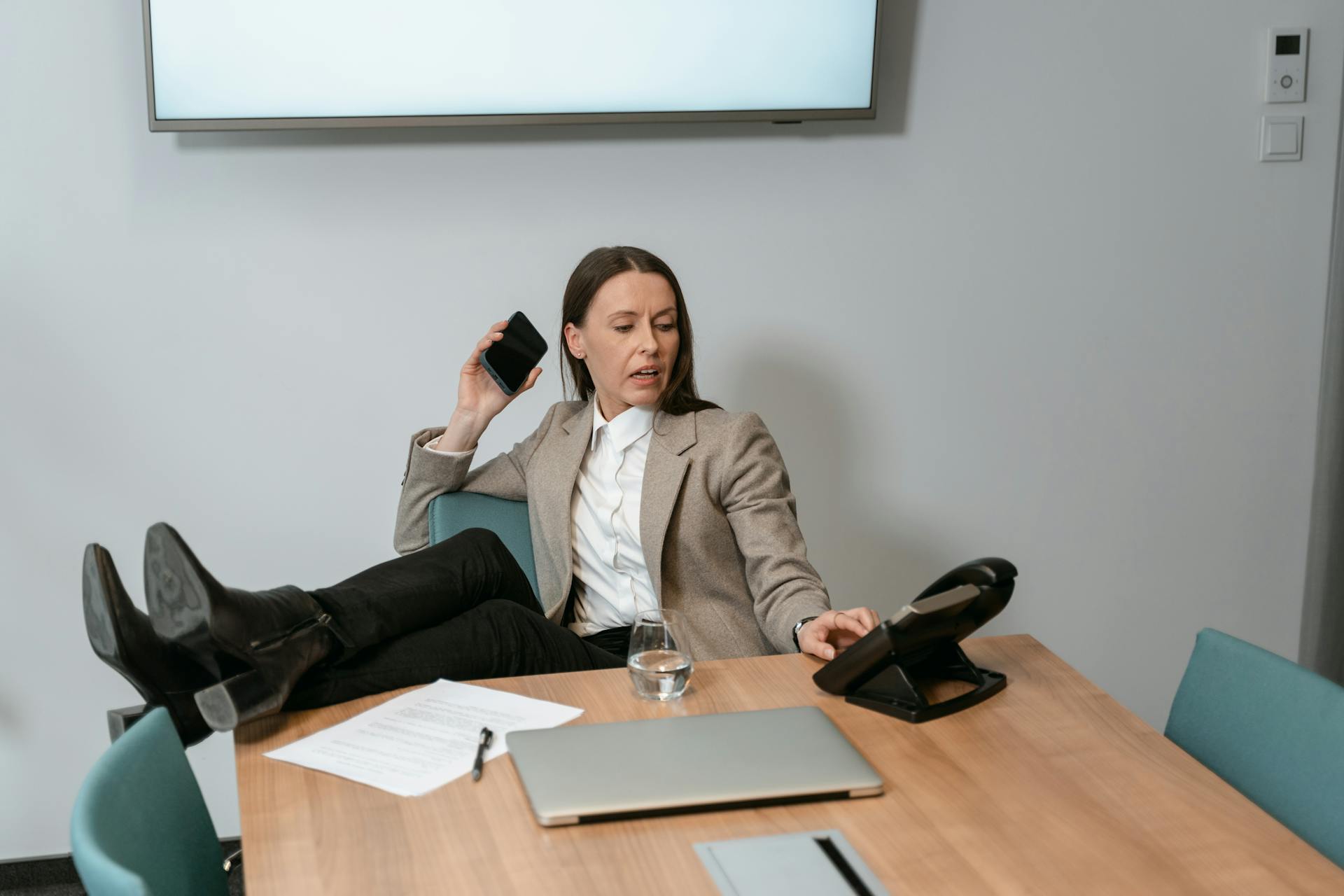 a busy woman sitting at a desk