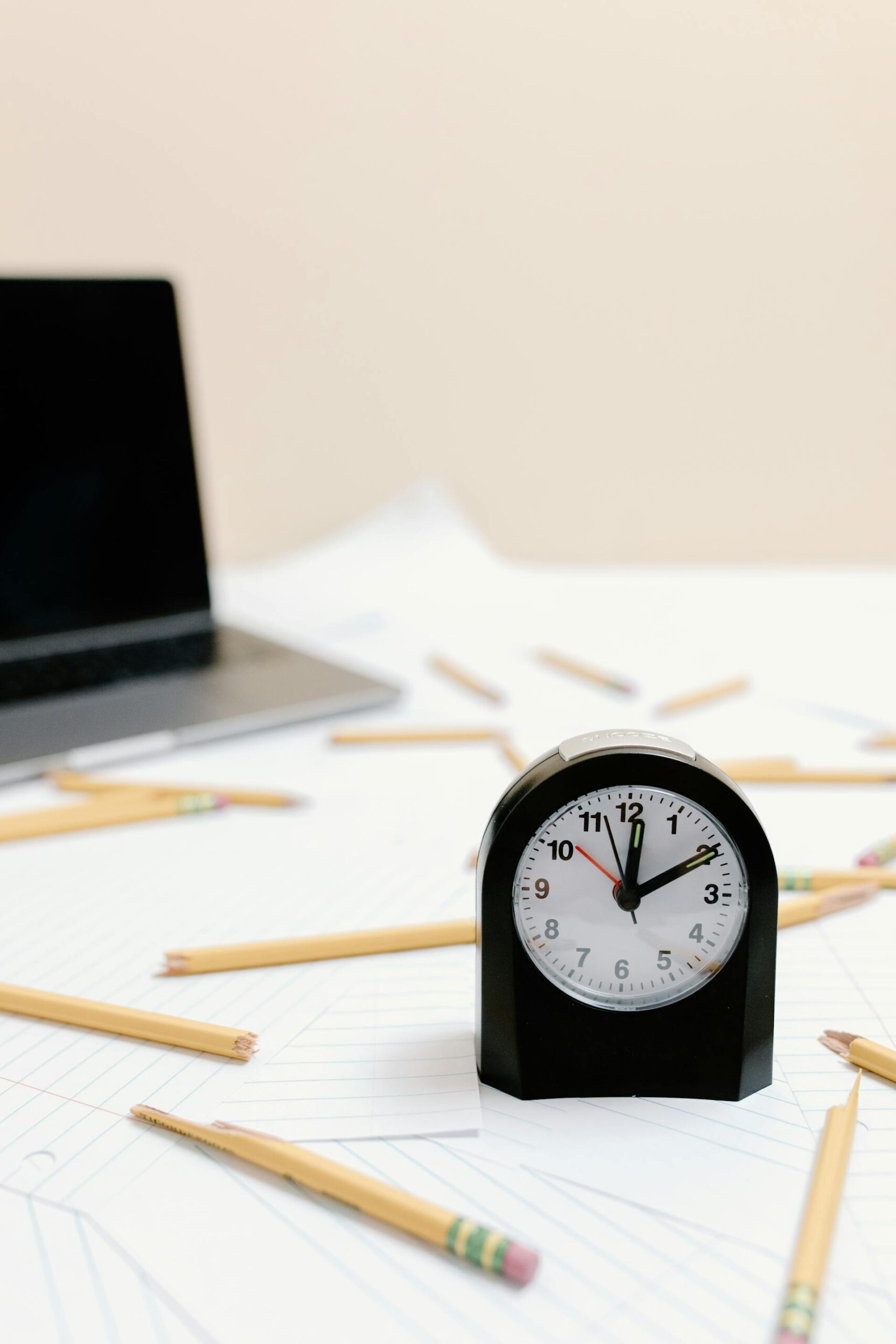 broken pencils on paper with a clock
