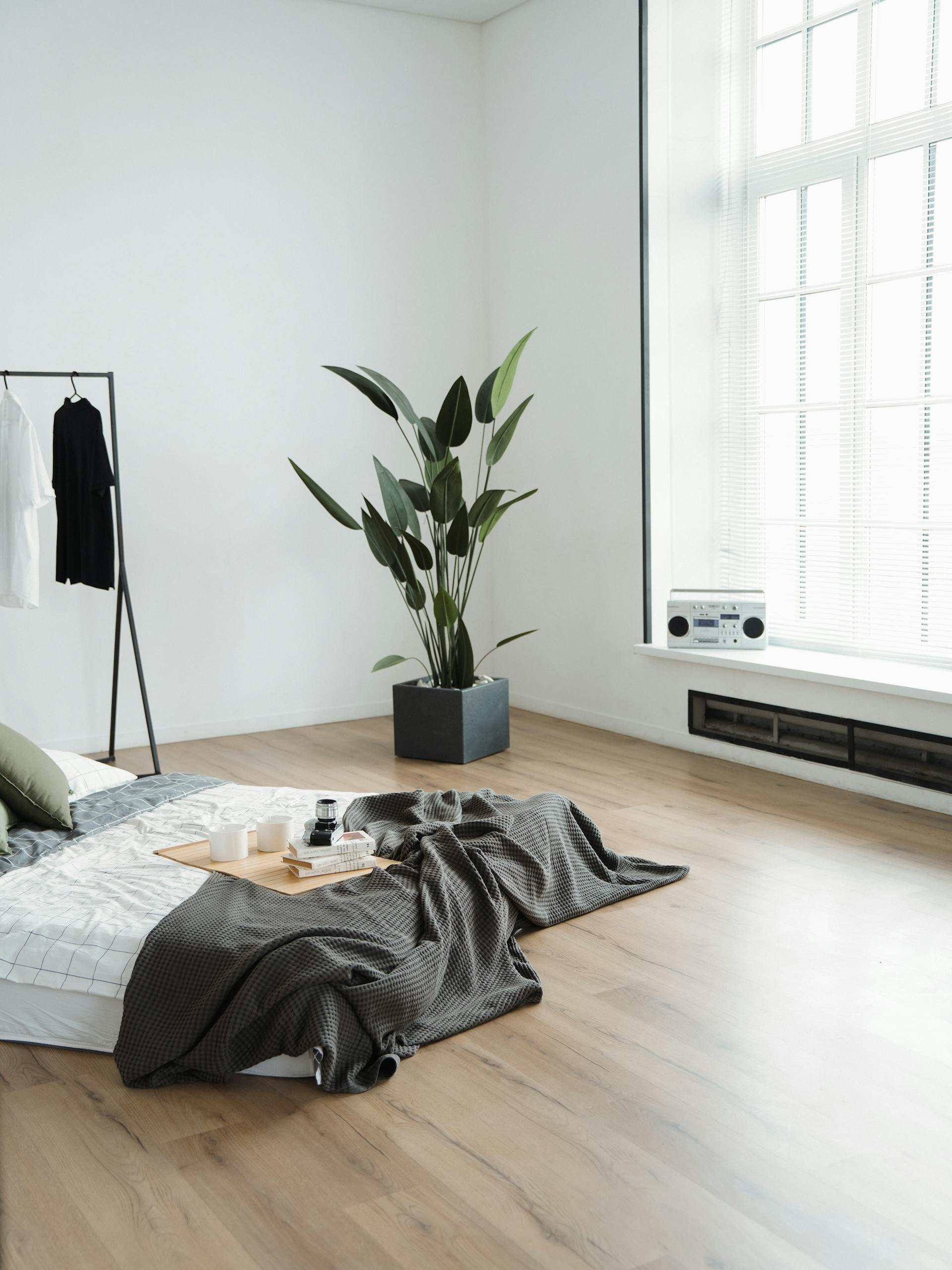 minimalist bed on floor with a tray of breakfast