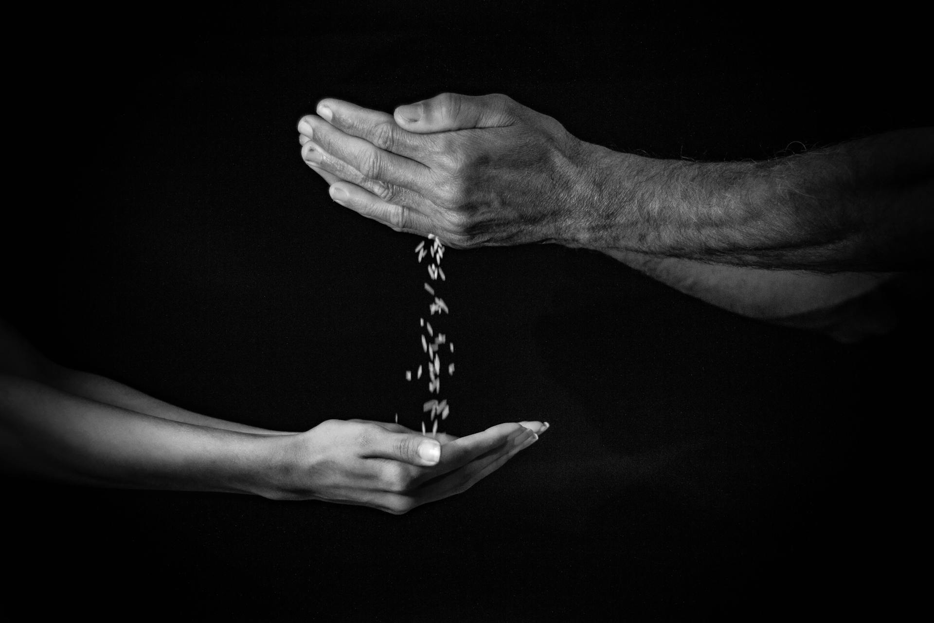 hands share seeds with each other in the spirit of generosity