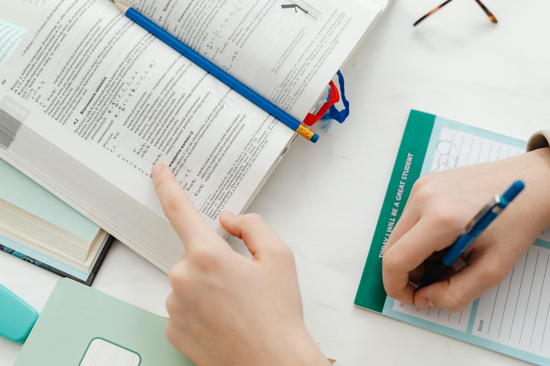 person studying and taking notes