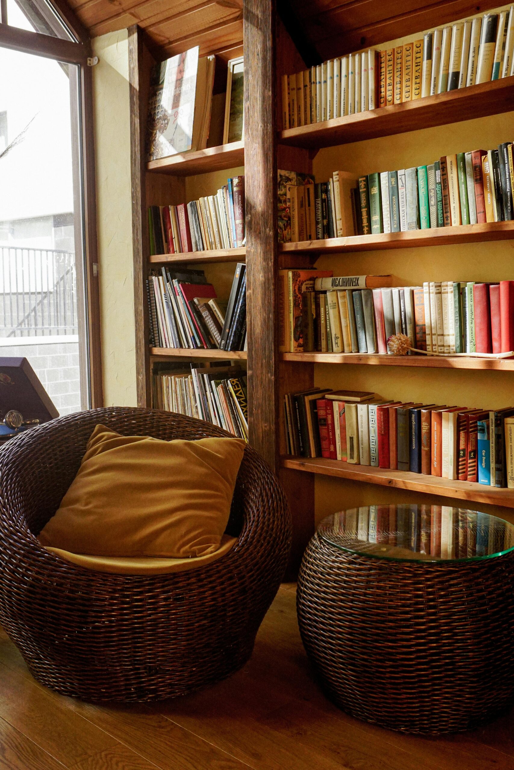 Book nook with natural sunlight and bohemian wicker seating.